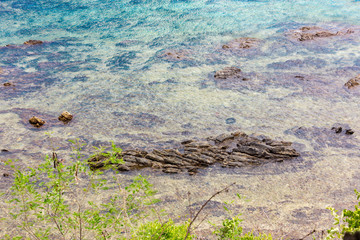 Beautiful reef and coral in shallow blue sea in day time, high angle view of seascape