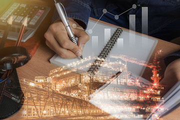 Business man with finances or accounting and offshore oil and gas industrial platform background concept.Double exposure of close up hand of men calculate bill expenses of finance and saving.