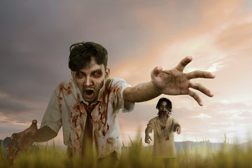 Two asian zombie man with mad face and dirty hand standing