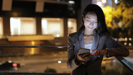 Business woman use of mobile phone in city