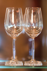 Empty glasses for wine on a bar rack in restaurant