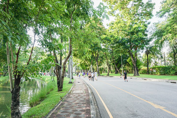 people exercise by jogging at public park in the evening after work