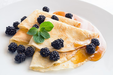 pancakes with blackberry and honey decorated with mint