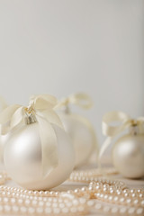 Fototapeta na wymiar Christmas and New Year. Christmas tree white toys with ribbon.