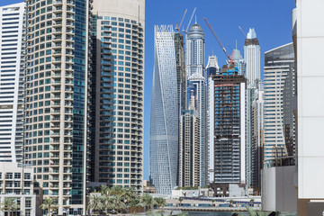 City scape with modern high-rise buildings and blue sky in background at Dubai.