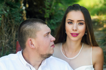 Obraz premium Beautiful wedding couple in a Park. Wedding day of a young couple . Portrait of the bride and groom close-up