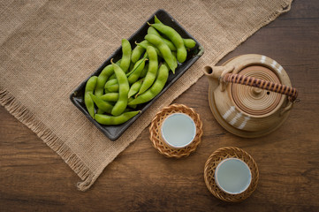 Japan pigeon pea or Edamame or Soybeans and tea pot on wooden table