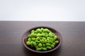 Japan pigeon pea or Edamame or Soybeans on wooden table with area for typography