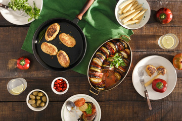 Ratatouille, chickpeas cutlets, lemonade, various snacks. Vegetarian dinner table concept