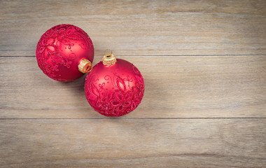 Red luxury Christmas balls isolated on wooden background.
