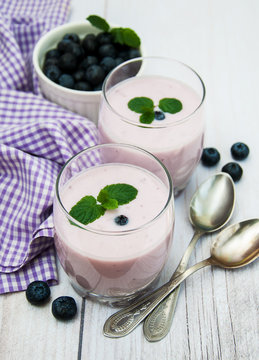 Glasses with blueberry yogurt on a table