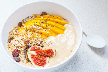 chocolate (carob) smoothie bowl of granola, mango and figs