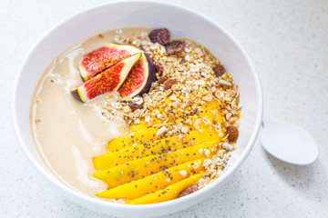 chocolate (carob) smoothie bowl of granola, mango and figs