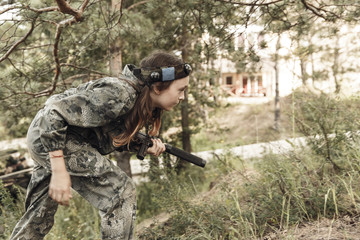 Young boy with gun, laser tag, war simulation