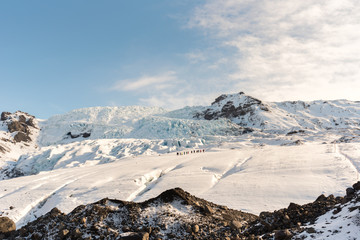 Group of people with backpacks and equipment hike on Glacier, Vatnajokull Nation park, Iceland.
