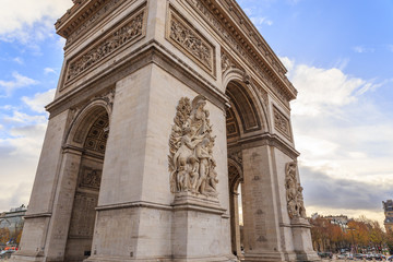 Fototapeta premium PARIS, FRANCE - The Arc de Triomphe de l'Etoile is one of the most famous monuments, View of the Champs-Elysees Avenue is full of stores, cafes and restaurants.