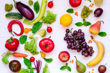Top view Assortment of bright organic fresh fruits and vegetables on the white wooden table. Healthy eating, diet, detox background.