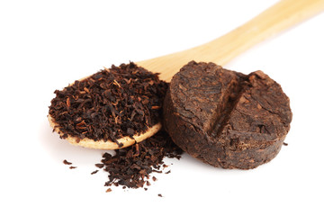 Round flat disc of puer tea isolated on white background. Pressed Chinese fermented Pu-erh tea