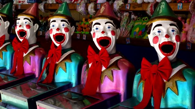 Iconic laughing clowns game stand, HD real time, handheld.