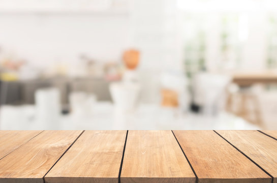 Empty wooden table and white modern kitchen cafe background,rasturant