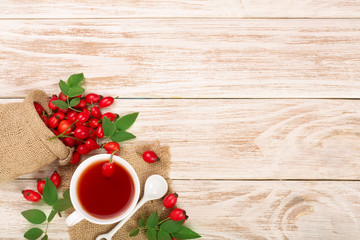 tea with rose hips and honey on white wooden background with copy space for your text. Top view