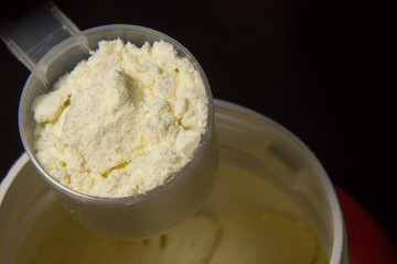 the whey protein powder closeup image black background
