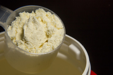 the whey protein powder closeup image black background