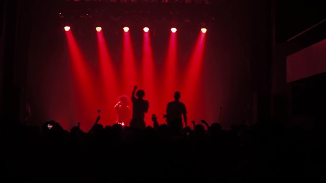 Silhouettes of rappers.