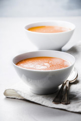 Homemade tomato soup (or gazpacho) over concrete background