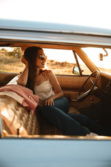 Fototapeta premium Vertical image of Smiling brunette woman in sunglasses