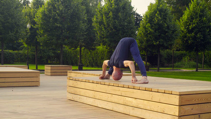 A man doing yoga exercises in the park