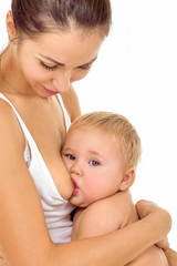 Young mother breastfeeds her baby. Breast-feeding.