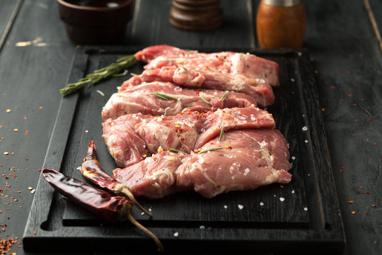 Raw pork steak with spices and rosemary