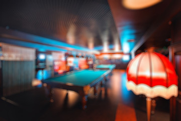 abstract blur. brand new and modern billiard interior in night time