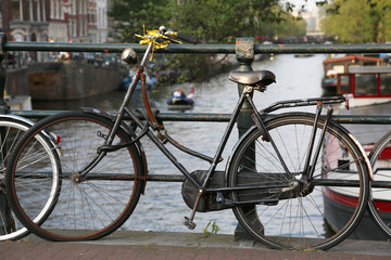 Naklejka na ściany i meble black bicycle over the bridge in Amsterdam city