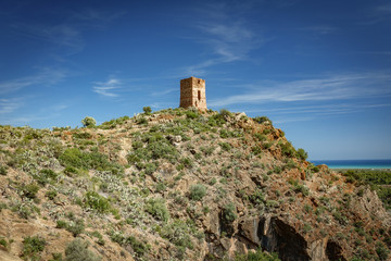 Fototapeta na wymiar Antique stone tower over hill