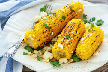 Grilled corn with butter, cheese and cilantro.