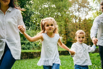 Fototapeta premium happy family running in city park