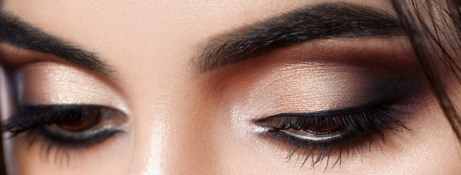 Closeup shot of woman eye with evening makeup. Long eyelashes. Smokey Eyes
