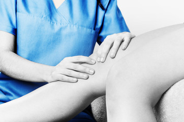 Physiotherapist, chiropractor doing a patellar mobilization, Knee pain in silhouette, color and black and white