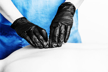 Physiotherapist, chiropractor giving a massage with gloves  to a patient  in silhouette isolated on white background. Color and black and white