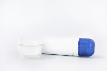 uhodovaya cosmetics. white cream in a glass jar. spray with a blue lid