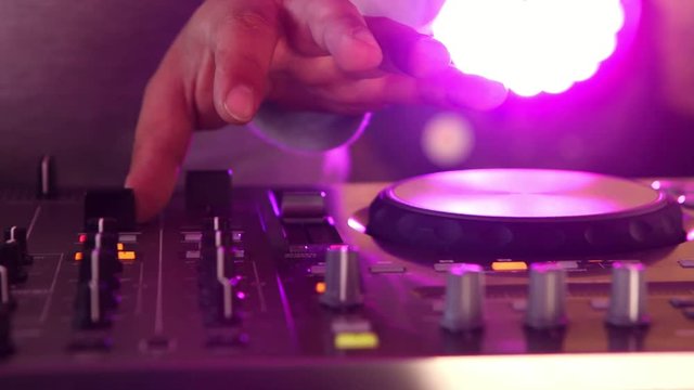 Colored discs playing in a discotheque on a DJ turntable
