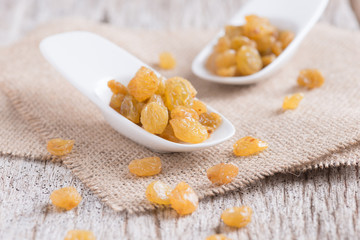 Dried yellow raisin fruits on  wood background