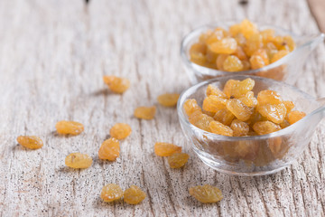 Dried yellow raisin fruits on  wood background