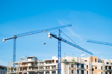 Crane, building and blue sky.