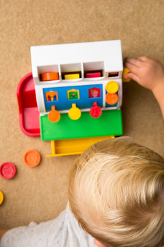 Child Learning To Count By Playing With Toy Till