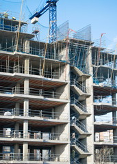 Crane, building and blue sky.
