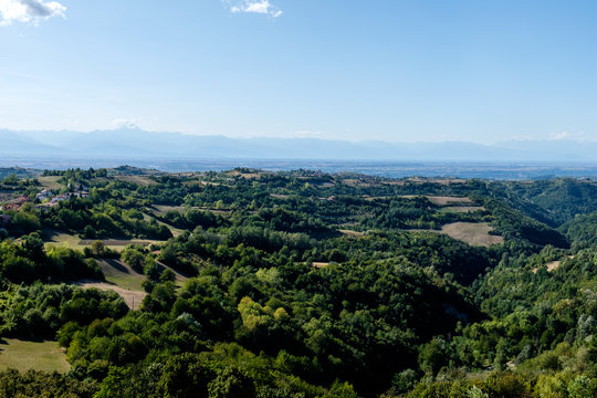 View of Langhe hills and of italian Alps from the top of the medieval tower of Murazzano, Piedmont, Italy.