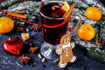 Christmas mulled wine with spices in cup on dark background